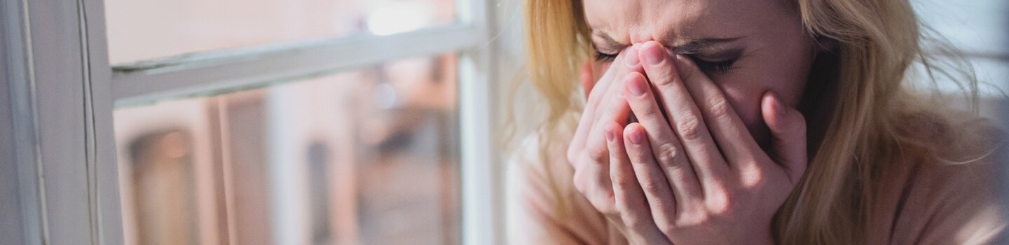 Woman crying in to her hands