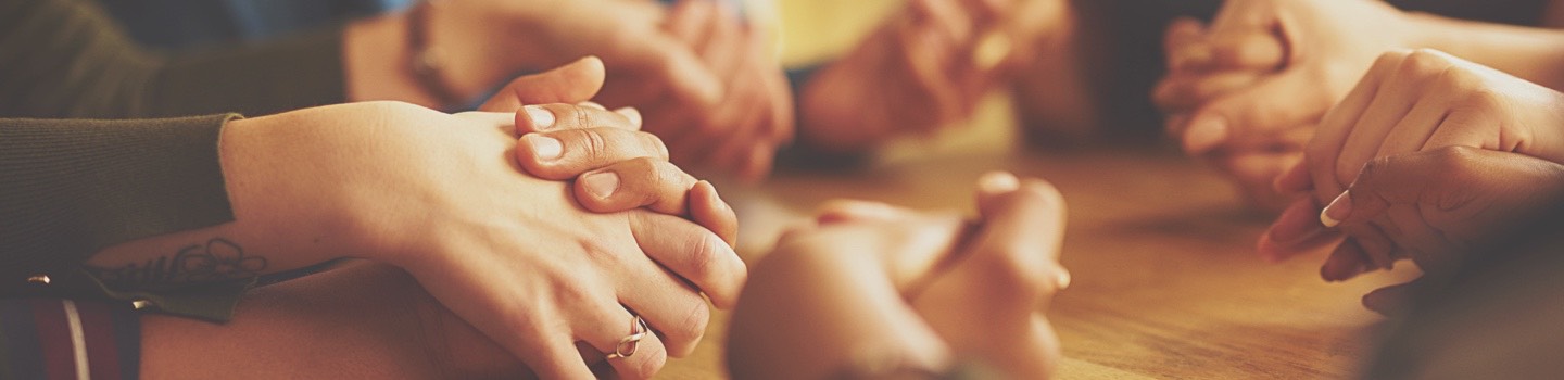 Group of people holding hands in support