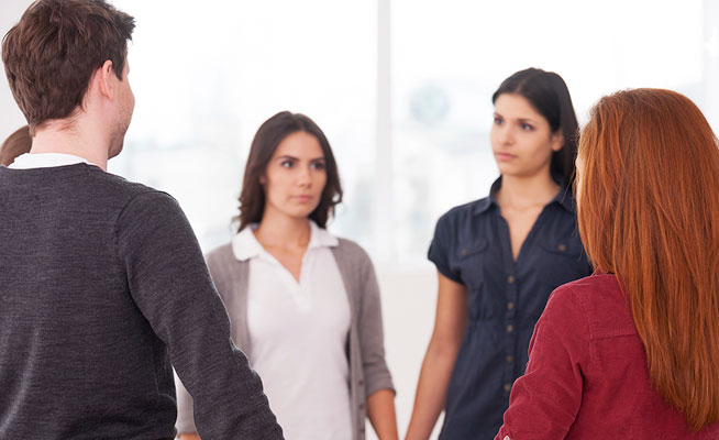 support group holding hands in a circle