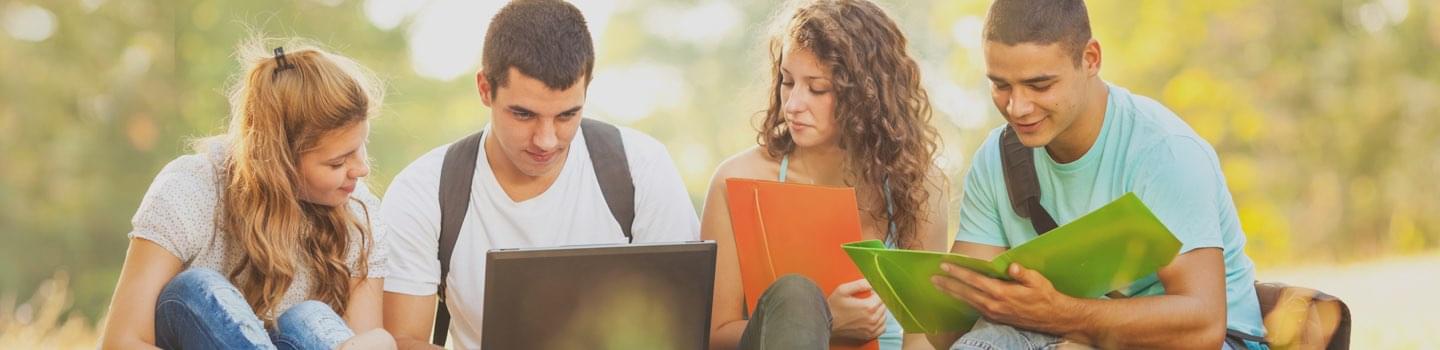 Young adults gathered around studying