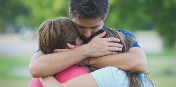 Man embracing his family