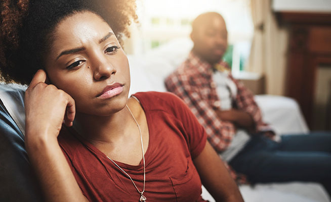 stressed woman with hands over her face