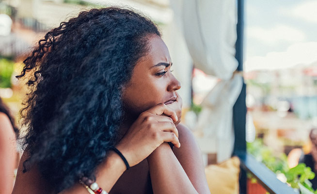 stressed woman with hands on her face