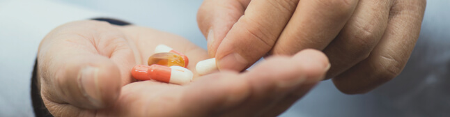 Pills in persons' hand