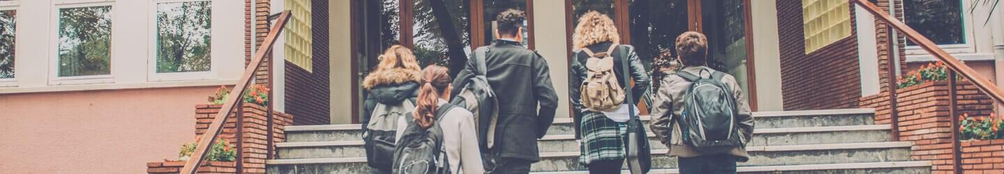 Young adults walking up campus stairs