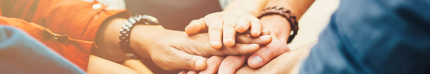 group of people with hands
together