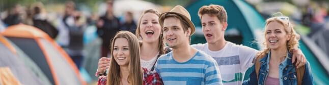 Small group of young adults and a festival.