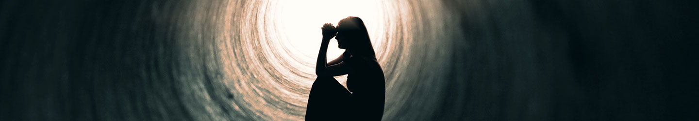 stressed woman sitting in a tunnel