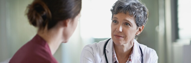 Woman speaking to nurse