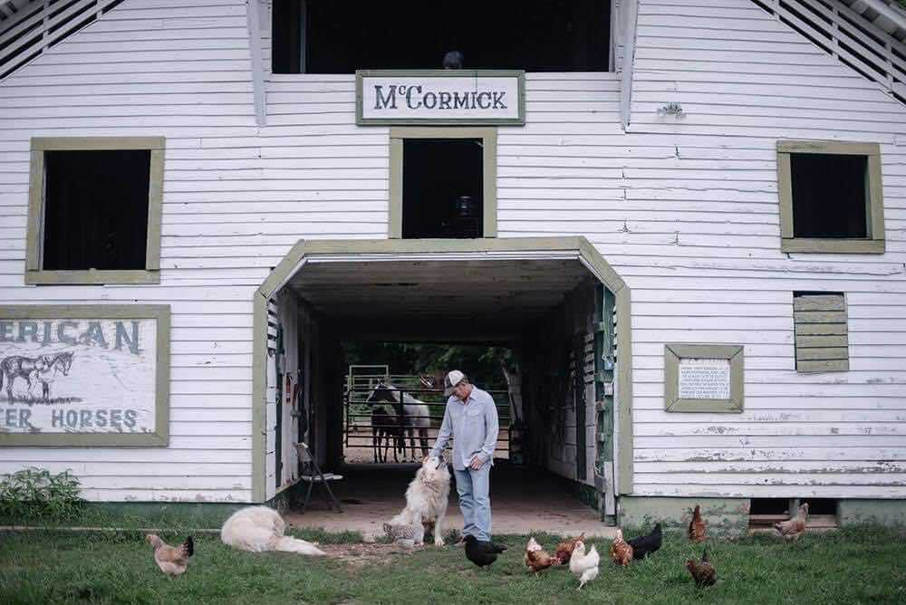 Lee McCormick at his barn with farm animals