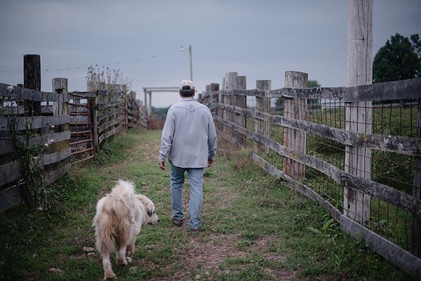 Lee McCormick on the farm with his dog.