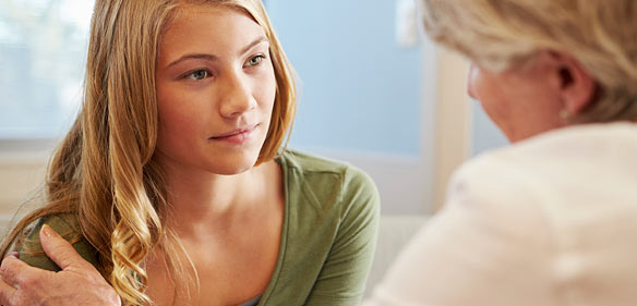 older woman talking to a teenager