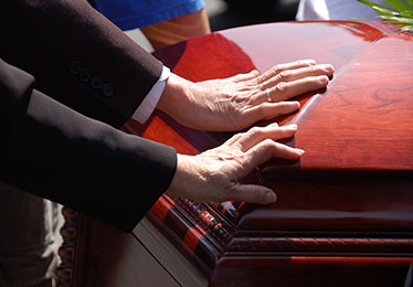 Family touching casket