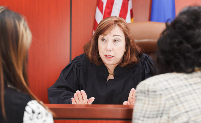 Judge speaking with defendant and lawyer