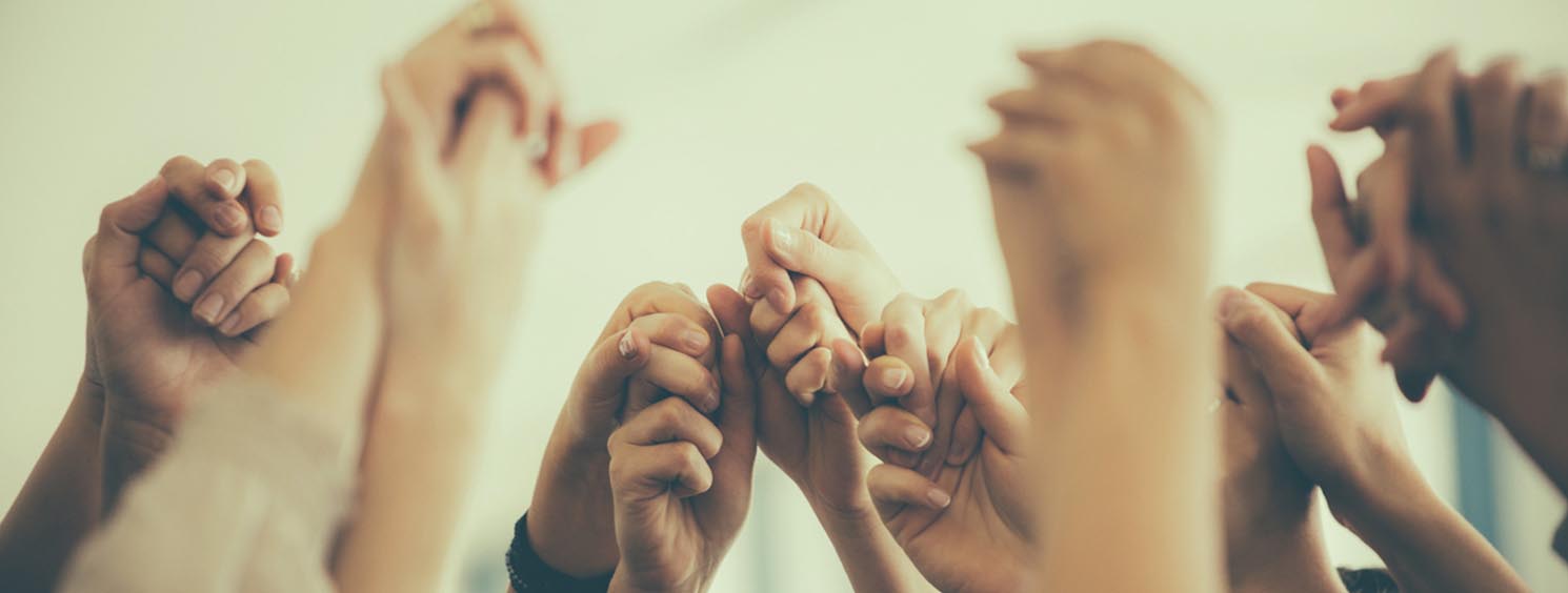 Image of teens holding hands in the air