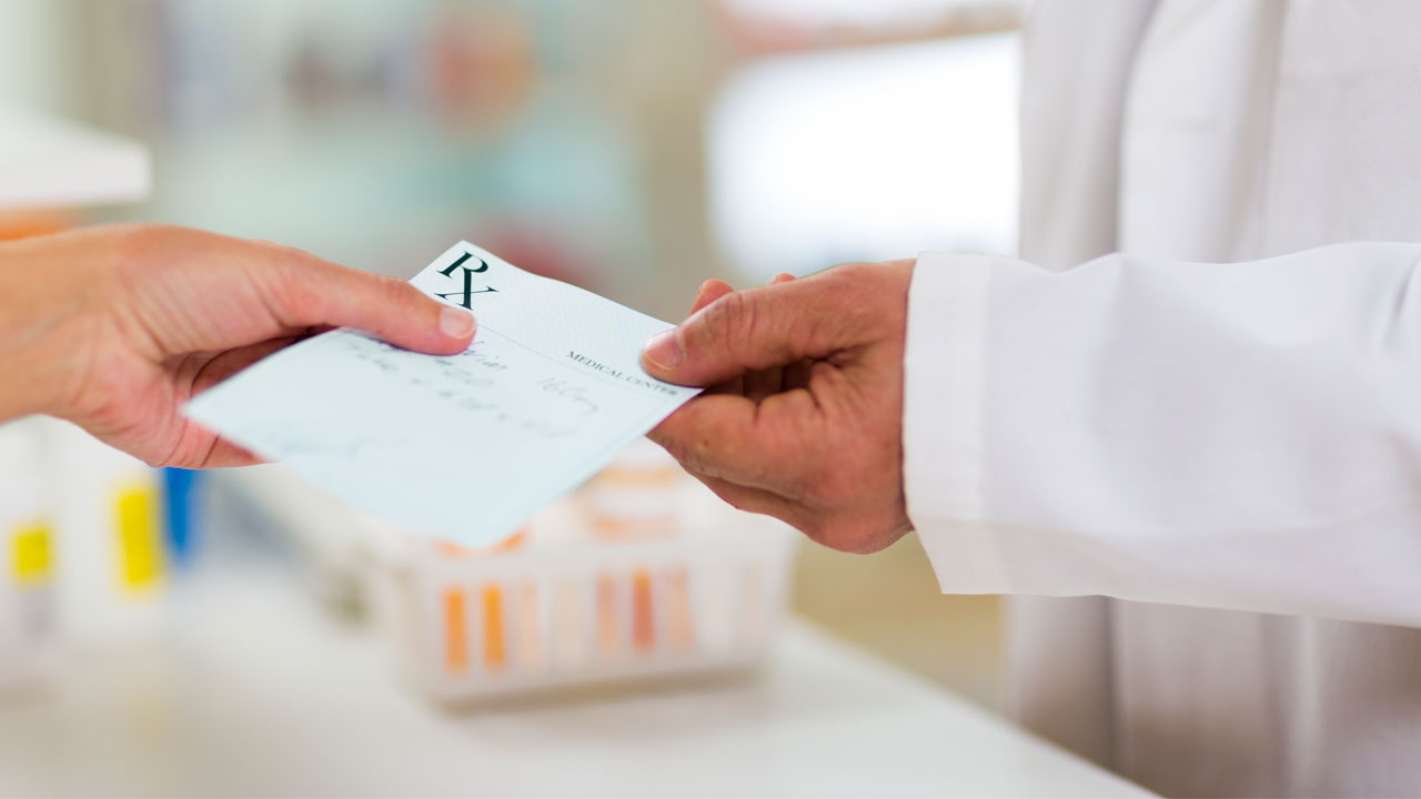 Patient taking prescription from Doctor