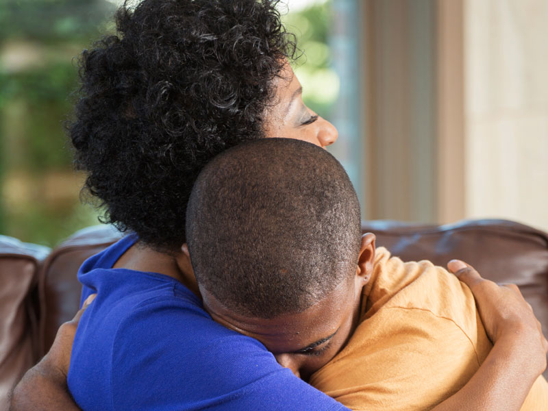 Mother hugging teen age son