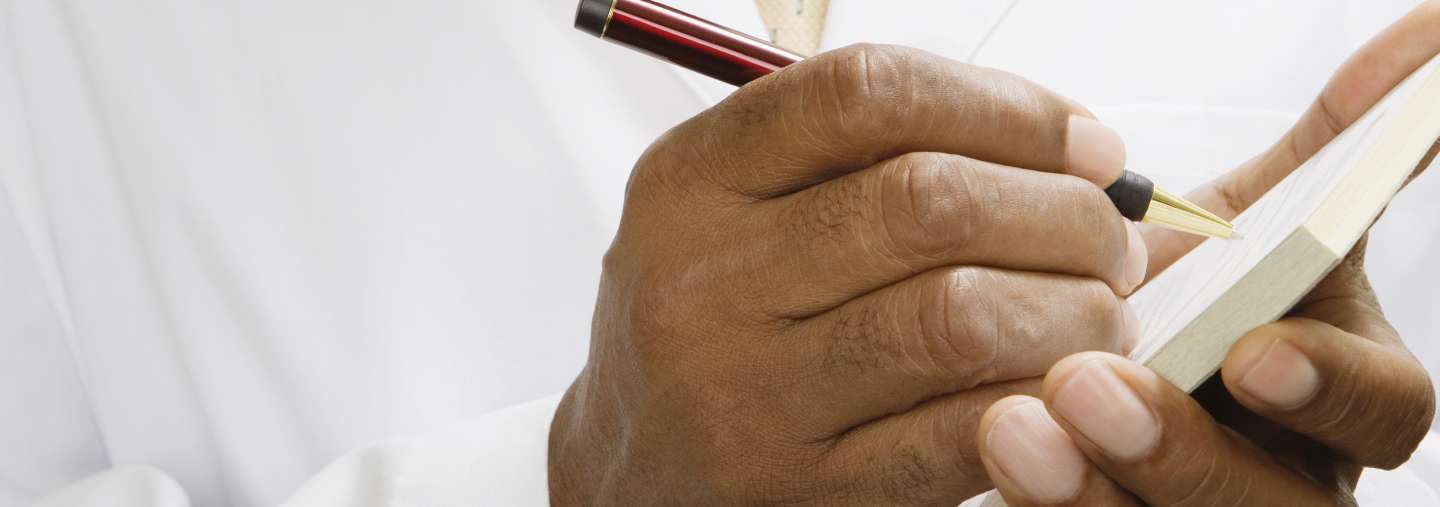 Doctor writing opioid prescription to patient