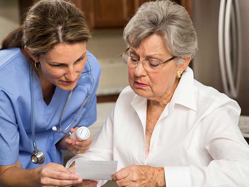 Young nurse helping an elderly woman