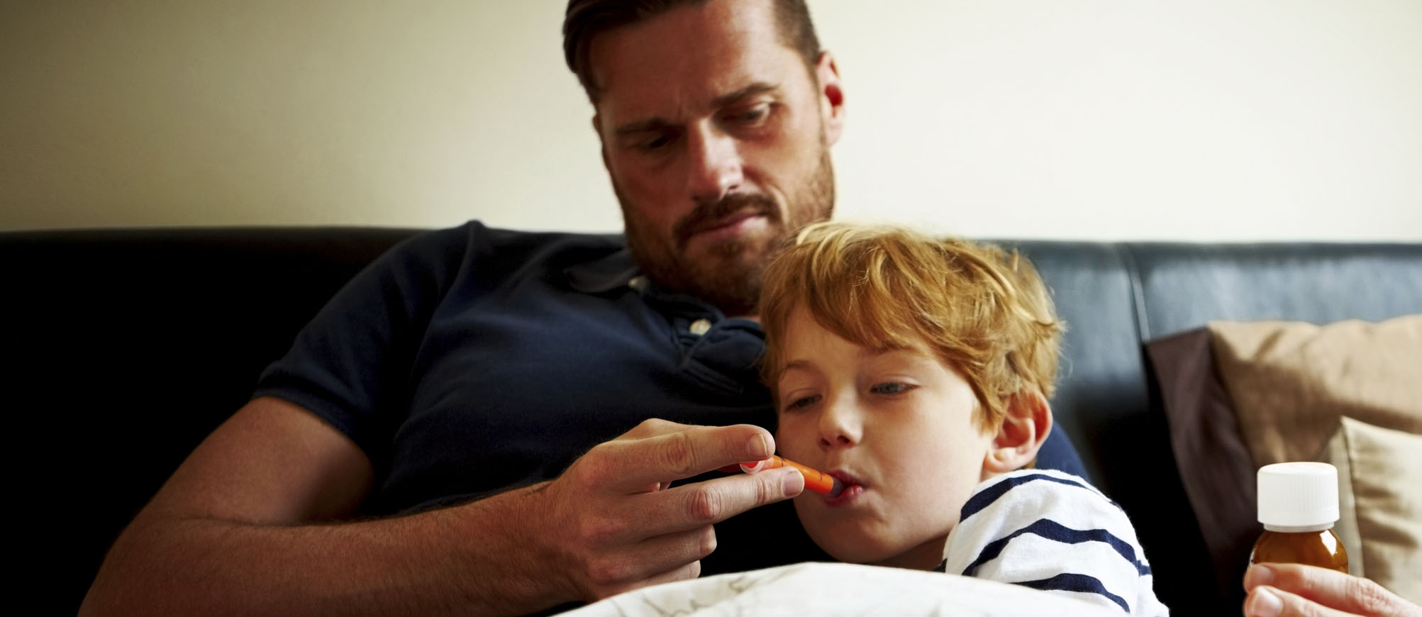 Father giving son prescription codeine cough syrup
