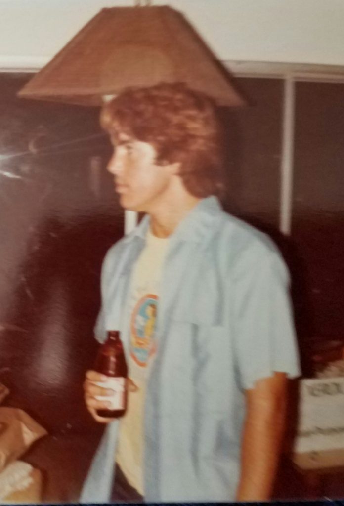 Young Randy holding beer